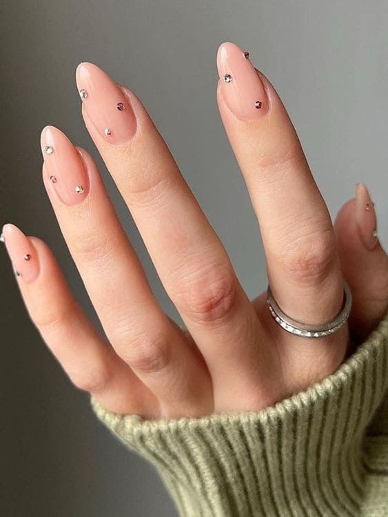 Chic Almond-Shaped Nails in Soft Nude with Sparkling Rhinestone Accents