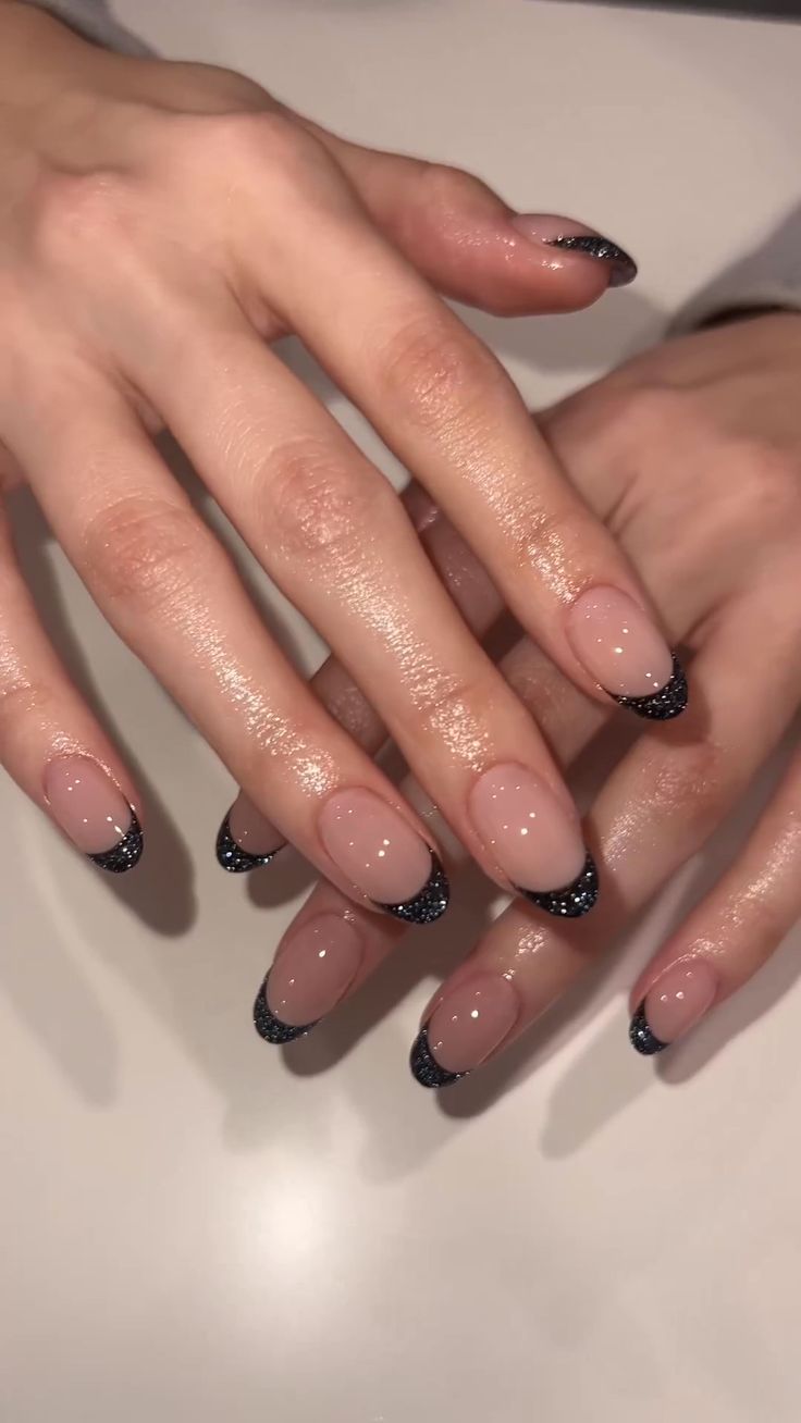 Chic Nude and Glossy Black Nail Design with Sparkling Tips for Sophistication.