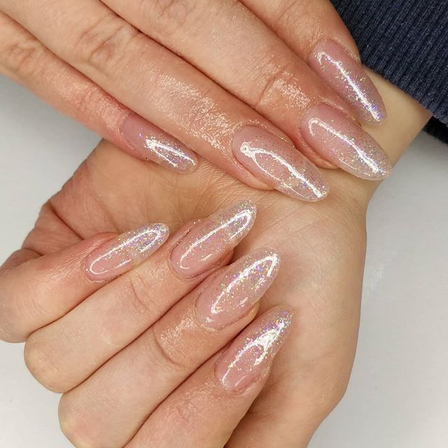 Elegant Glitter Ombre Almond Nail Design with Iridescent Accents.