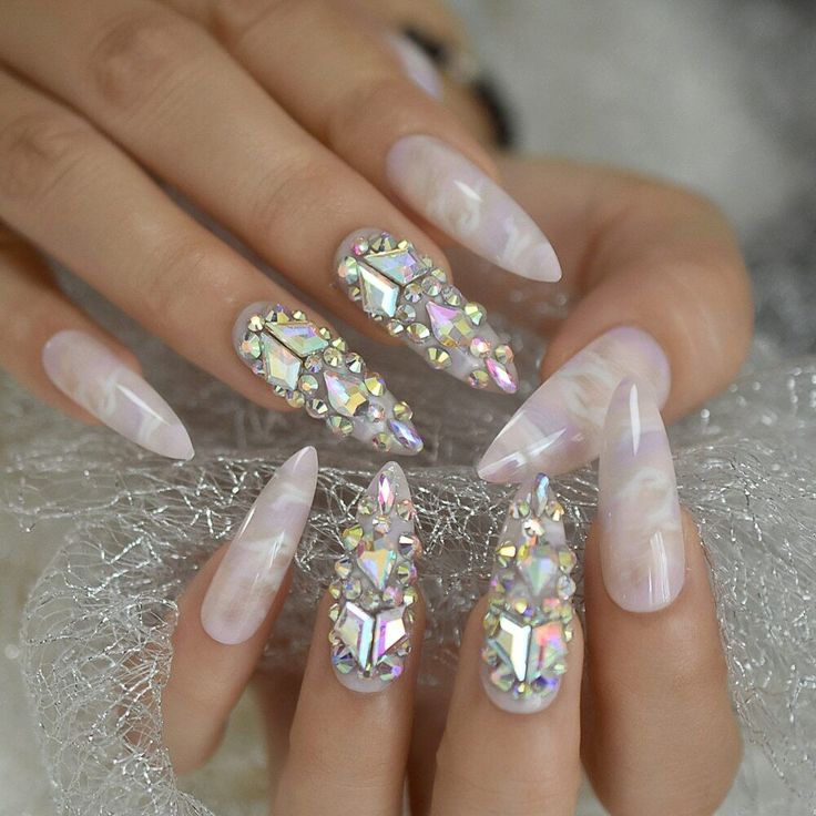 Chic Almond-Shaped Nail Design with Iridescent Rhinestones for Glamorous Occasions.