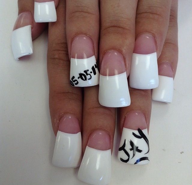 Chic French Tip Nails: Glossy White Finish with Artistic Elements for Sophisticated Elegance.