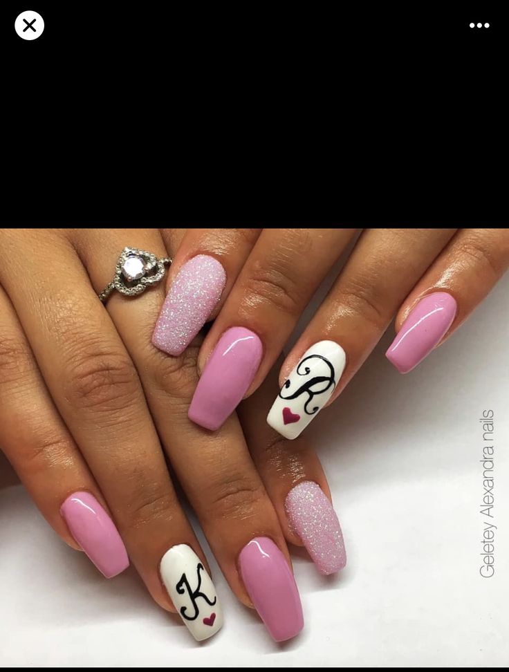 Elegant and Playful Soft Pink Nail Design with Sparkling Accents and Intricate Details.