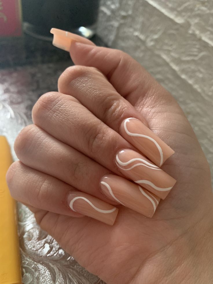 Chic Nude Nail Design with Elegant White Waves in Sophisticated Squoval Shape