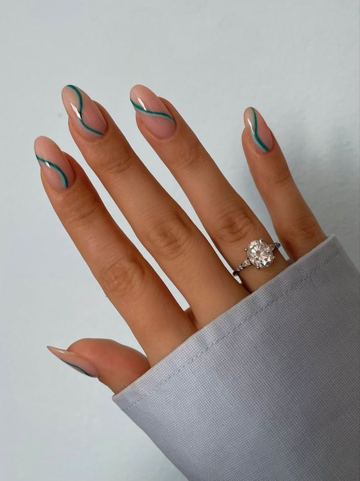 Chic Elegant Nail Design: Nude Base with Turquoise Fluid Lines and Sparkling Accent.