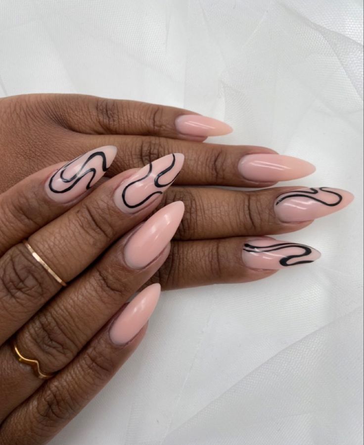 Chic Almond-Shaped Nails: Elegant Nude Base with Artistic Black Lines