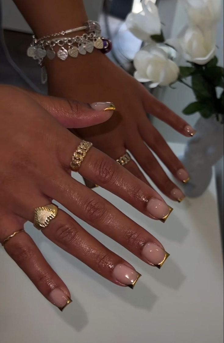 Chic Gold-Tipped Nude Manicure for a Modern and Sophisticated Look.