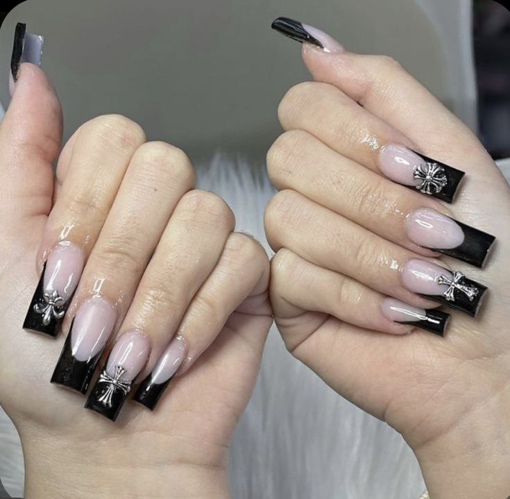 Sophisticated Elegant Black and Nude Nails with Glossy Finish and Silver Bow Embellishments.