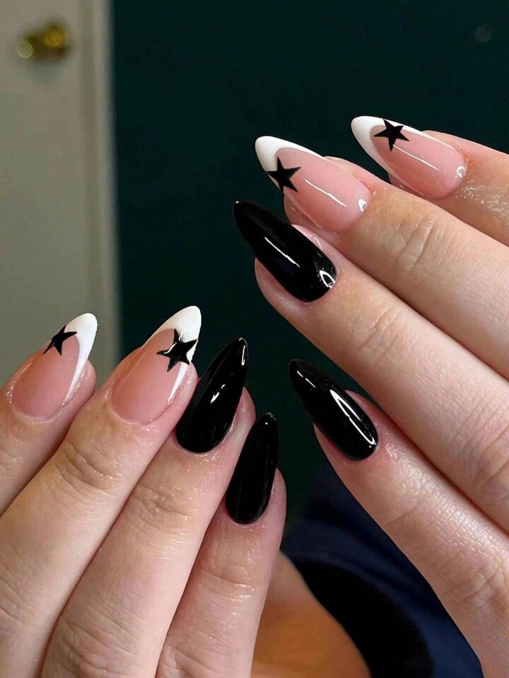 Chic Almond-Shaped Nail Design: Elegant Black, Nude, and White Tips with Bold Star Accents.