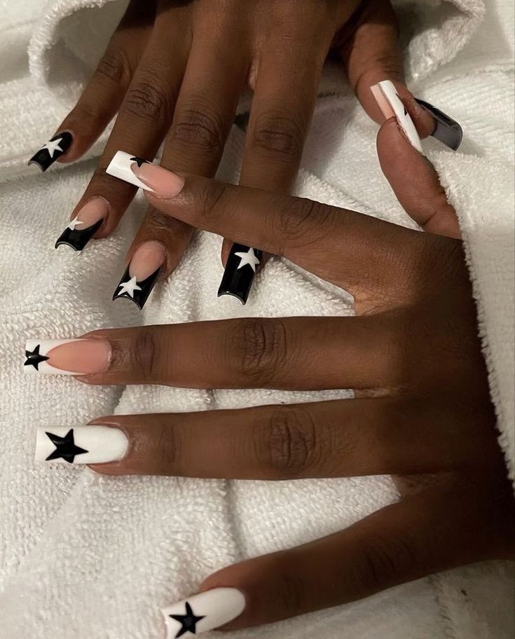 Eye-Catching Star-Themed Nail Design with Bold Black and White Contrast