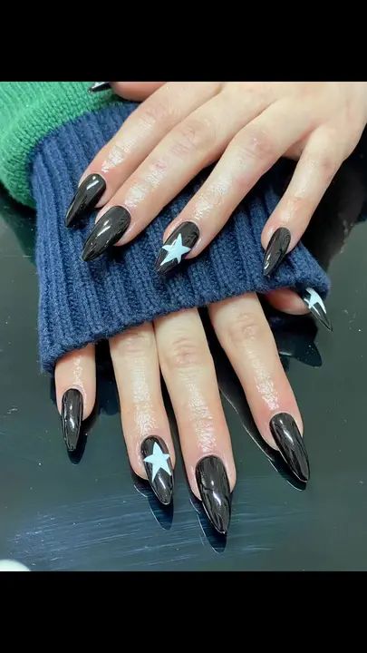 Chic Star-Themed Manicure with Bold Black and White Design on Long Pointed Nails