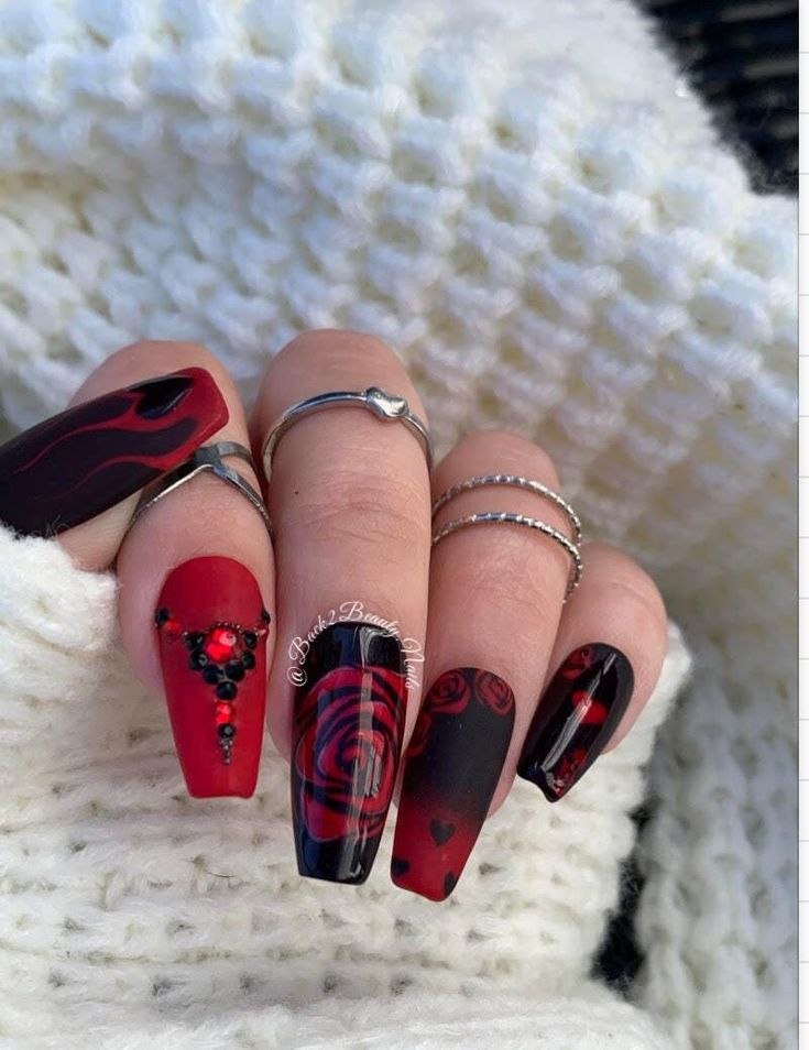 Bold Gothic Nail Design with Dark Red and Black Intricate Patterns and Gem Accents.