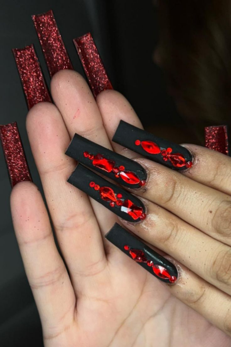 Striking Black Nails with Glossy Red Accents and Glamorous Glitter Tips.