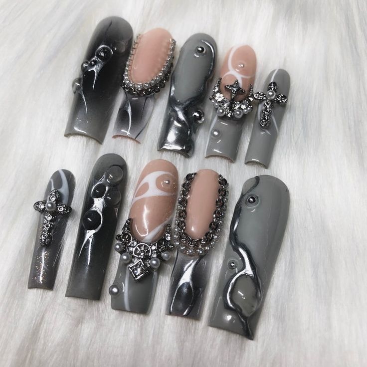 Sophisticated Gray and Nude Nail Set with Intricate Designs and Elegant Accents.