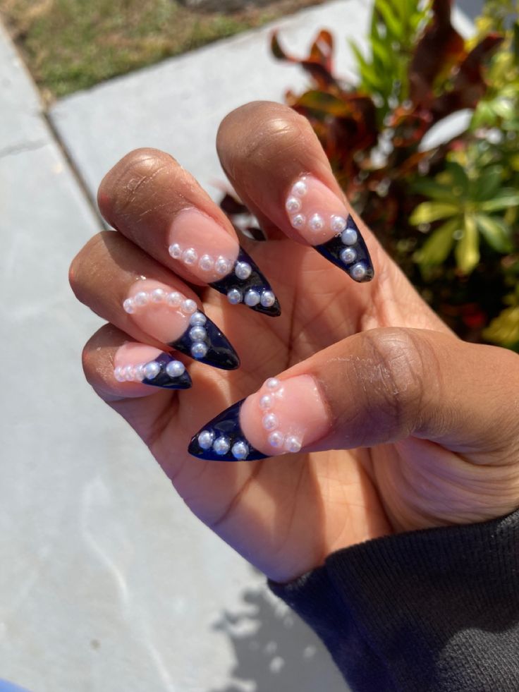 Chic Nail Design: Nude and Deep Navy with Glossy Black Tips and Pearl Accents