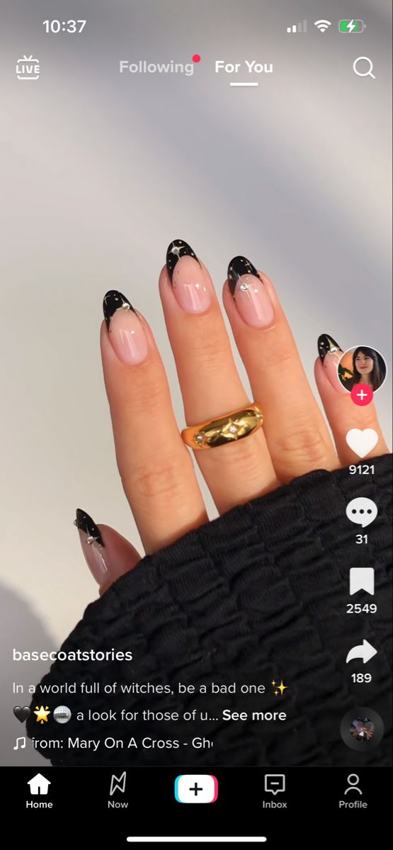 Elegant Black and Clear Nail Design with Gold Accent.