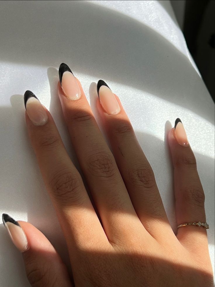 Chic French Tip Nail Design with a Modern Twist: Soft Nude Base and Bold Black Tips