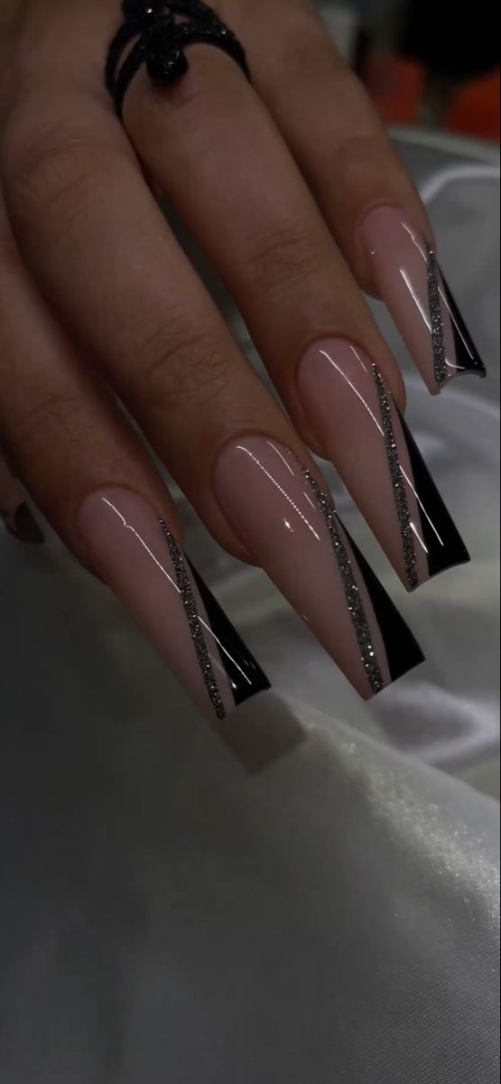 Elegant Nude and Black Nail Design with Silver Accents for Chic Occasions.