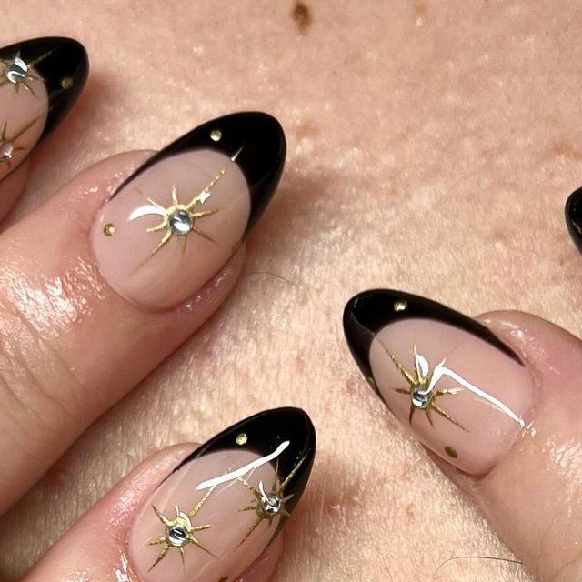 Chic Almond-Shaped Nails: Striking Black French Tips with Gold Accents and Sparkling Rhinestones