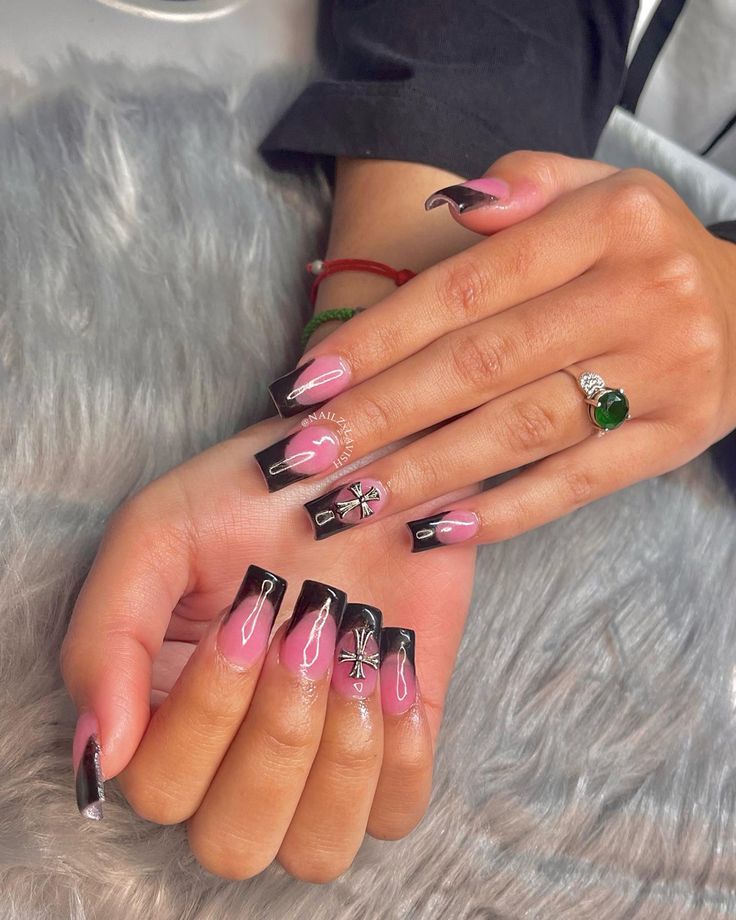 Sophisticated Nail Design: Soft Pink with Bold Black Tips and Intricate Floral Artistry.