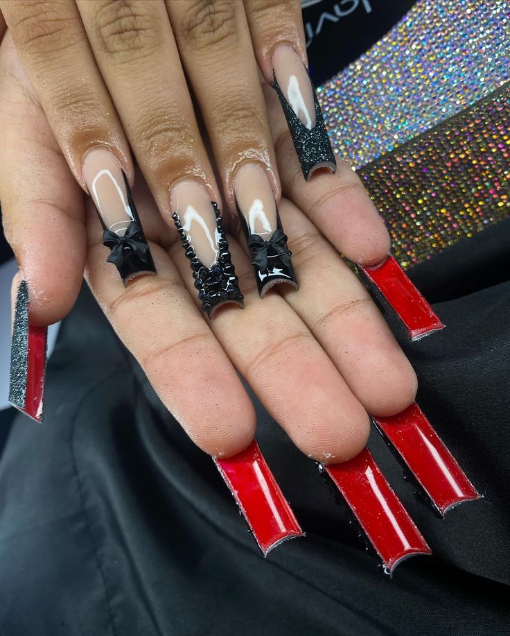 Edgy Elongated Stiletto Nail Design with Bold Black and Glossy Red Accents