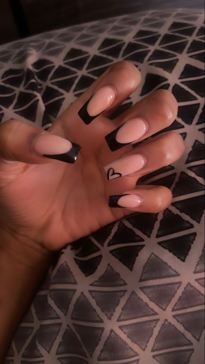 Elegant Chic Nail Design with Nude and Black Contrast and Playful Heart Accent.