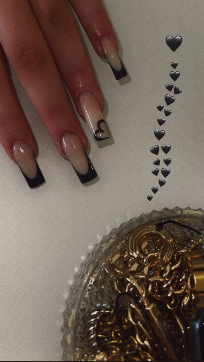 Trendy Nude Ombre Nails with Striking Black Tips and Charming Heart Detail