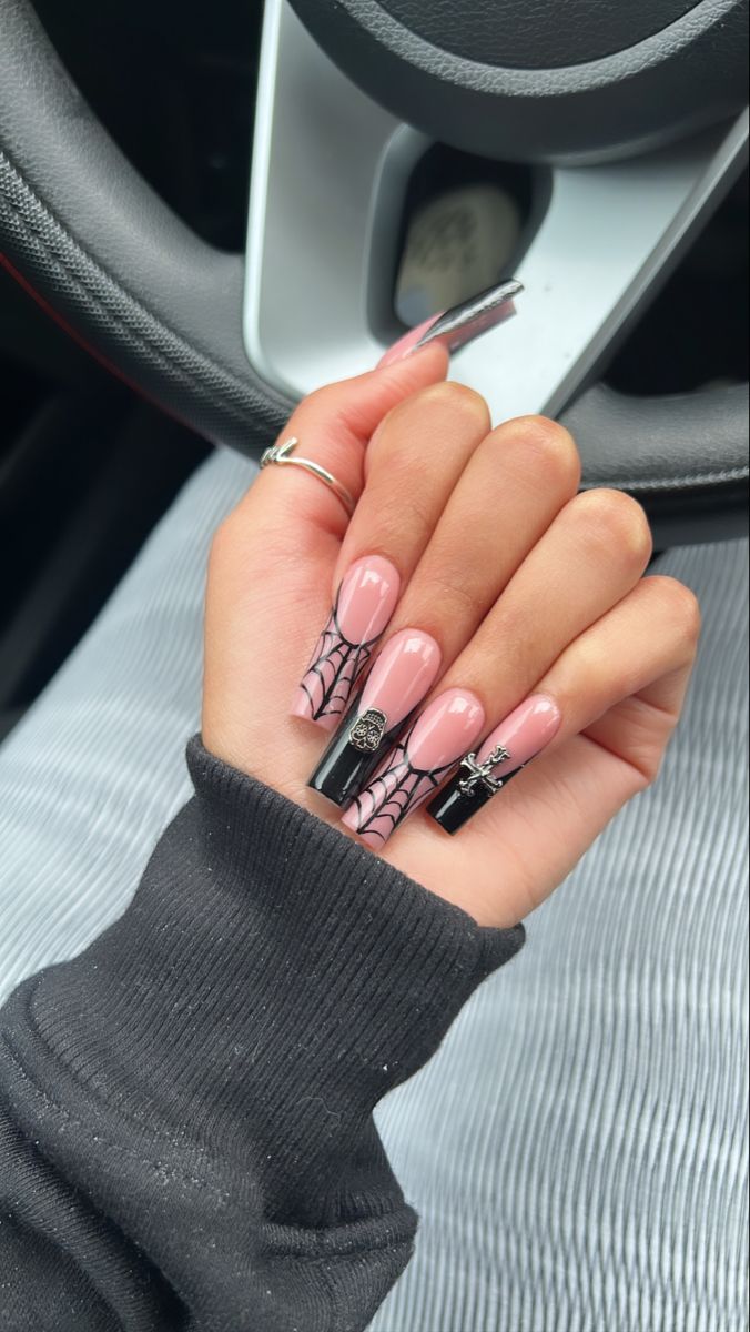 Sophisticated Nail Design: Elegant Pink Base with Gothic Black Elements and Intricate Spider Web Patterns.