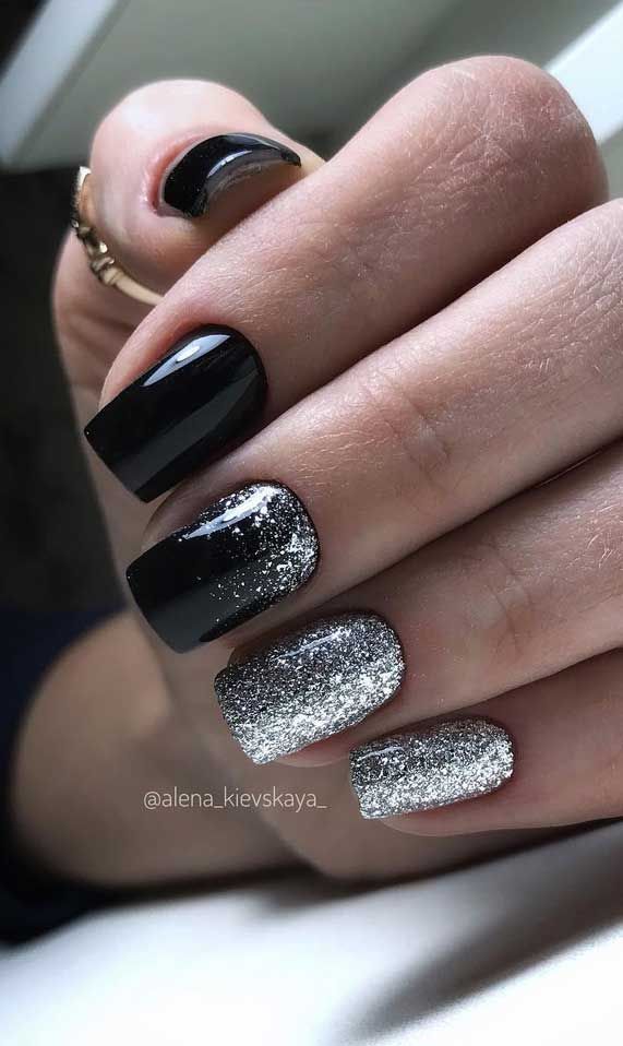 Bold and Sophisticated Nail Design: Glossy Black Meets Shimmering Silver Glitter.