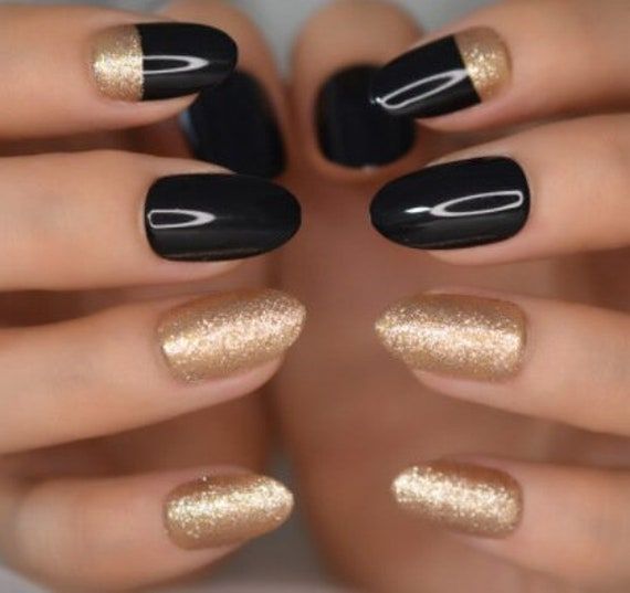 Chic Glossy Black and Shimmering Gold Nail Design with Elegant Half-Moon Accents.