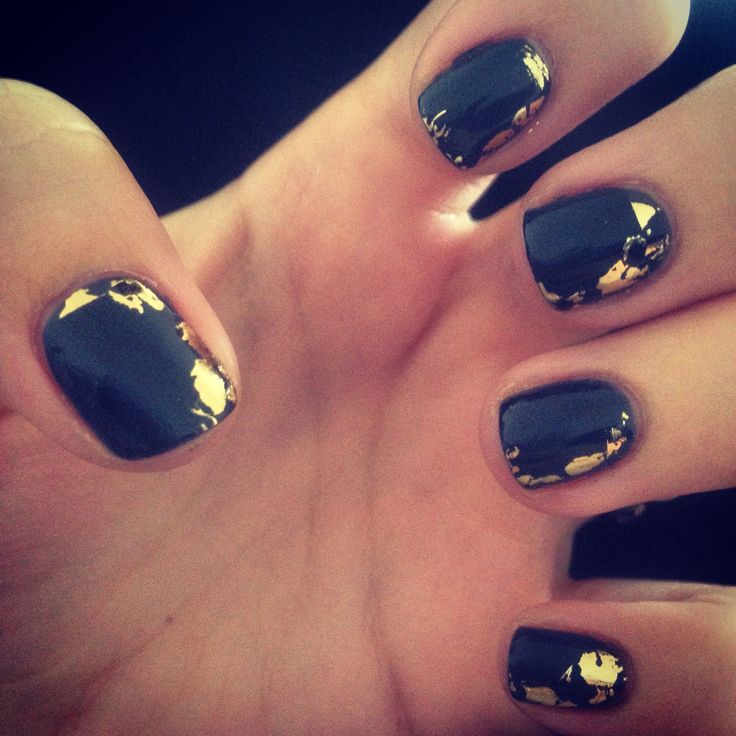 Sophisticated Black Nail Design with Glamorous Gold Foil Accents