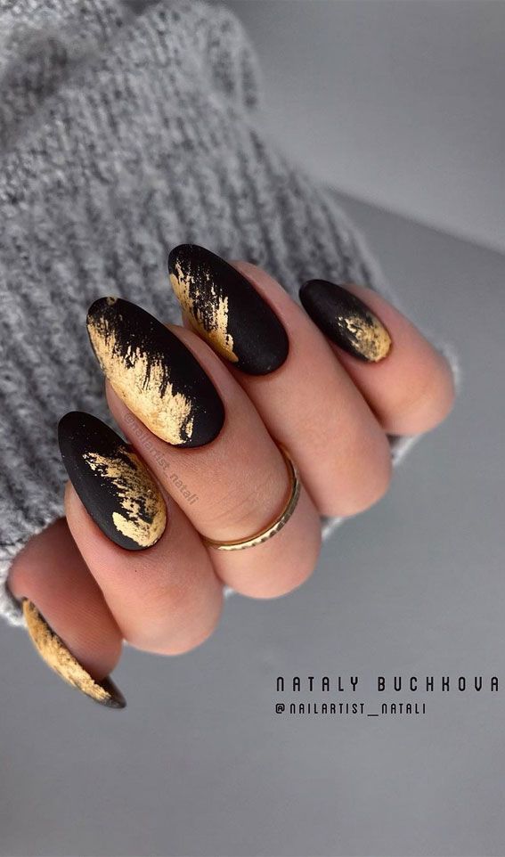 Elegant Matte Black and Glossy Gold Almond Nail Design for a Glamorous Look.