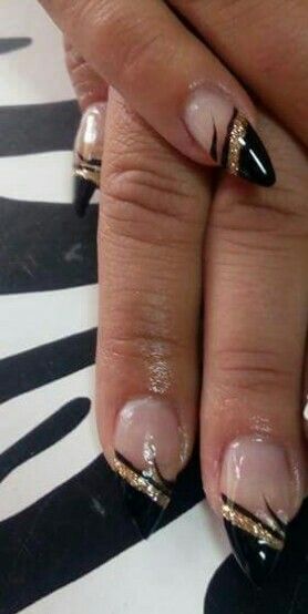 Elegant Nude and Black Nail Design with Golden Glitter Accents.