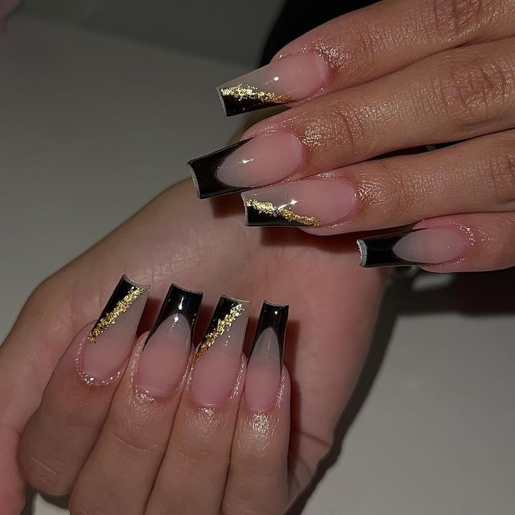 Elegant Black and Nude Acrylic Nails with Dramatic Tips and Gold Accents