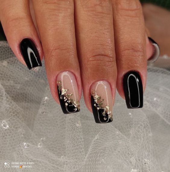 Sophisticated Nail Design: Glossy Black and Nude Contrast with Golden Accents on Square Nails.