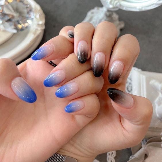 Stunning Ombre Nail Design: Gradient of Blue and Black for a Bold yet Elegant Look.