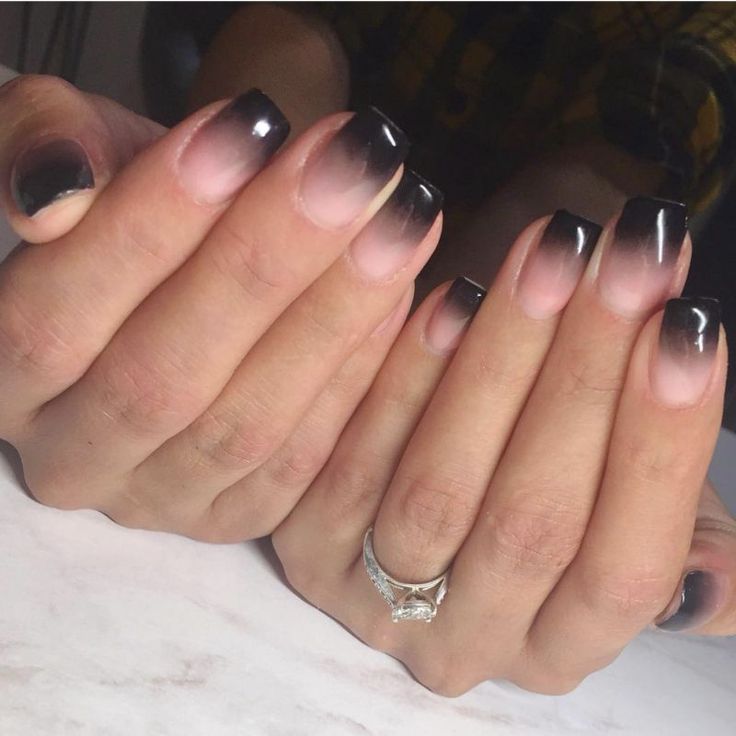 Chic Ombre Nail Design: Dark Black to Soft Nude Gradient with Minimalist Silver Accent.