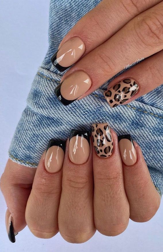 Chic Nail Design: Elegant Beige and Bold Black Tips with Trendy Animal Print Accent