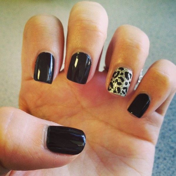 Chic Black Matte Nail Design with Glamorous Leopard Accent.