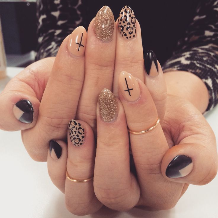 Chic Manicure: Glittery Gold, Sleek Black, and Animal Print Fusion with Geometric Accents.