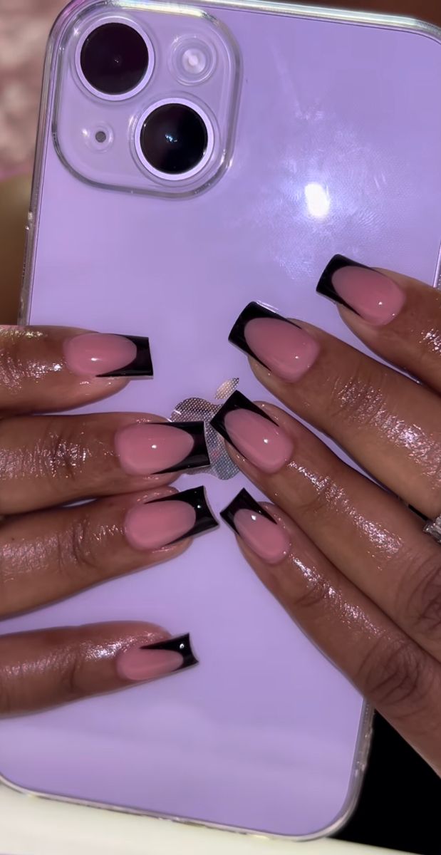 Chic French Tip Nail Design: Soft Pink Meets Bold Black Elements.