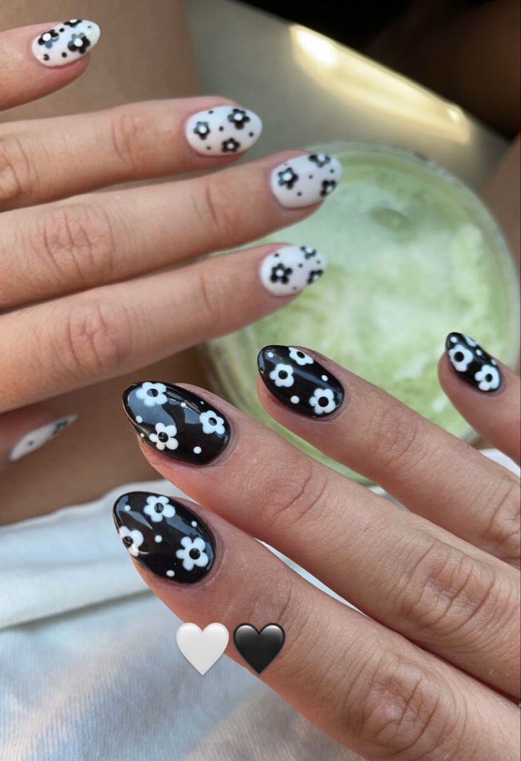 Trendy Black and White Floral Nail Design with Glossy Contrasts.