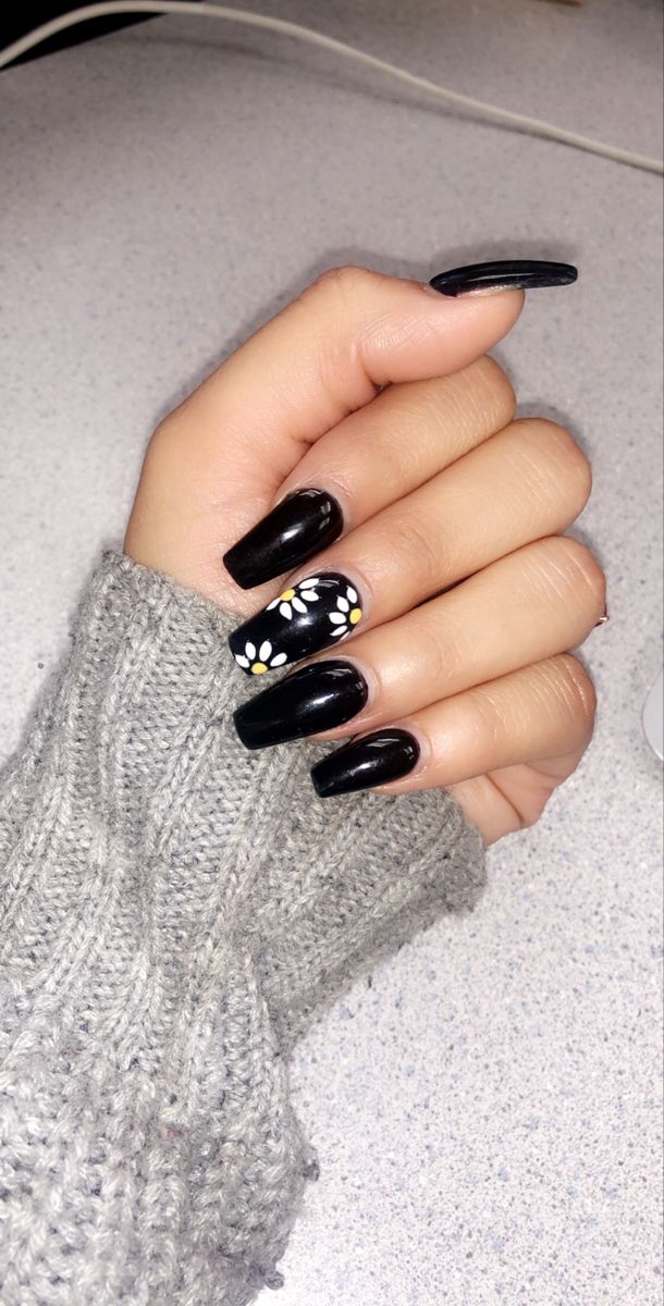 Bold Black Nail Design with Glossy and Matte Finishes Featuring Floral Accents.