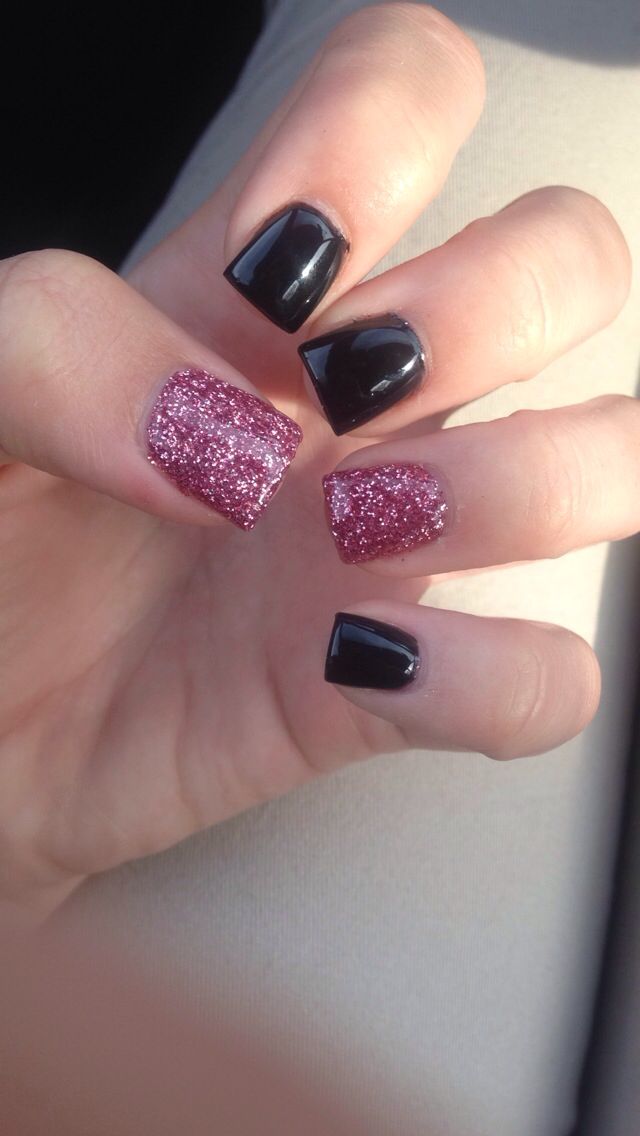 Chic Black and Sparkling Pink Glitter Nail Design: A Sophisticated Yet Playful Look.