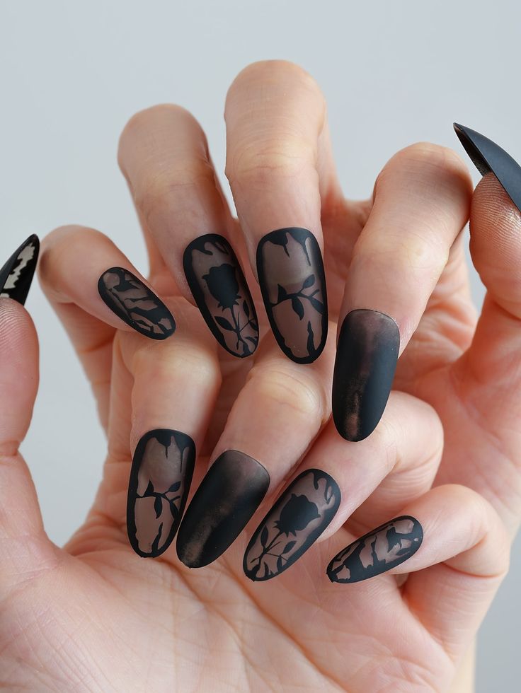 Sophisticated Matte Black Nail Design Featuring Intricate Floral Patterns and Striking Color Contrast.