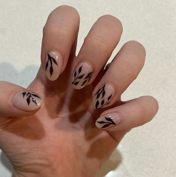 Chic Minimalist Nude Nail Design with Black Leaf Patterns