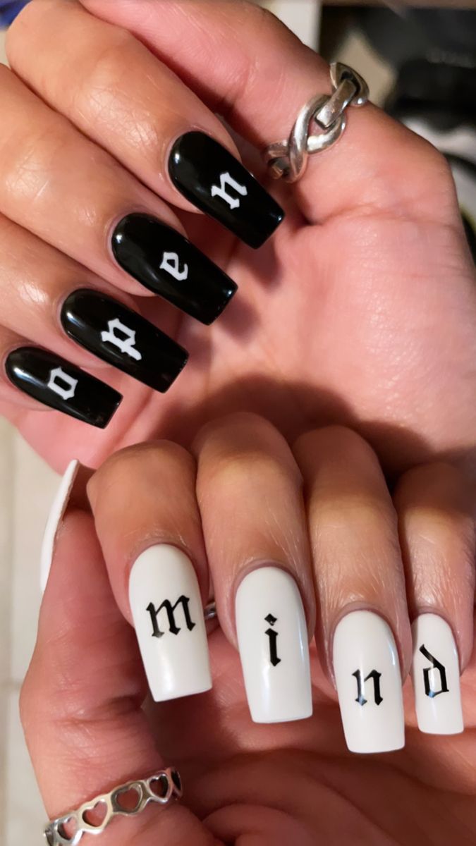 Bold and Stylish Black and White Nail Design with Unique Lettering.