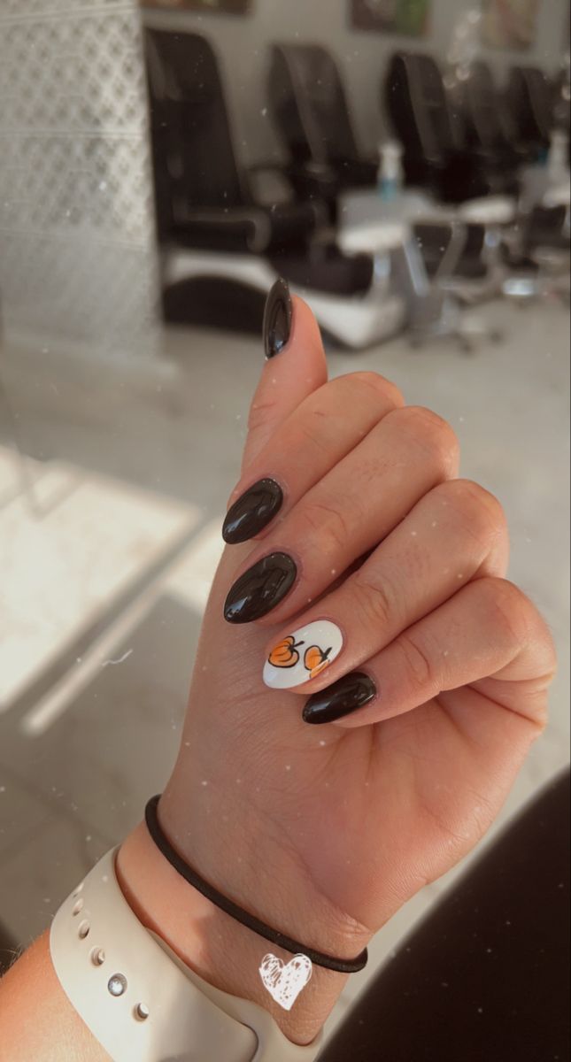 Chic Glossy Black Almond Nails with Playful Illustrated Accent.