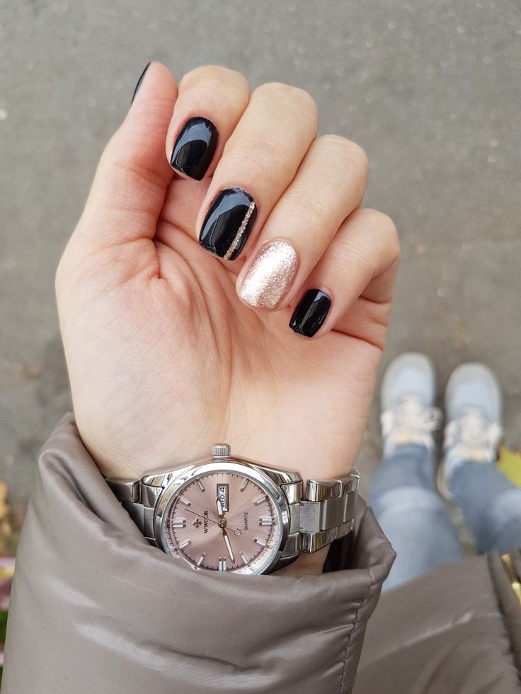 Elegant Glossy Black and Shimmering Rose Gold Nail Design for Sophisticated Style.