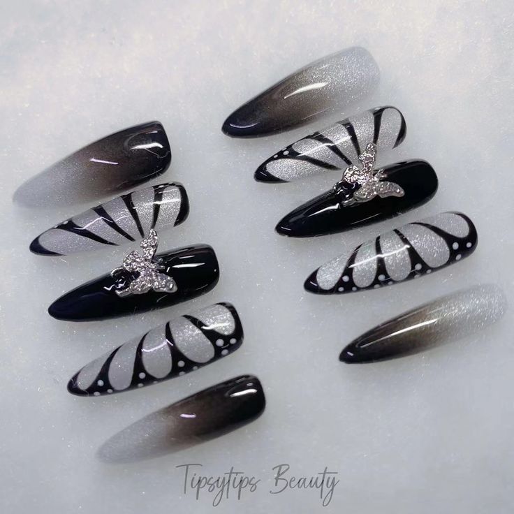 Elegant Black and Silver Nail Design with Butterfly Accents and Gradient Effect.