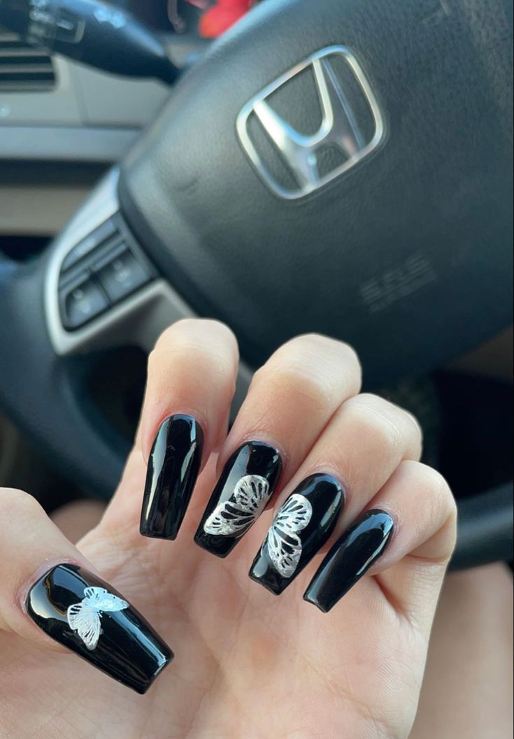 Sophisticated Black Nail Design with Delicate White Butterfly Art